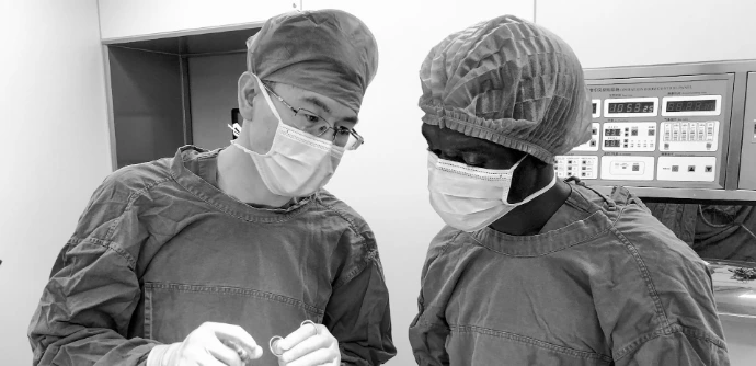 man in black jacket wearing white mask
